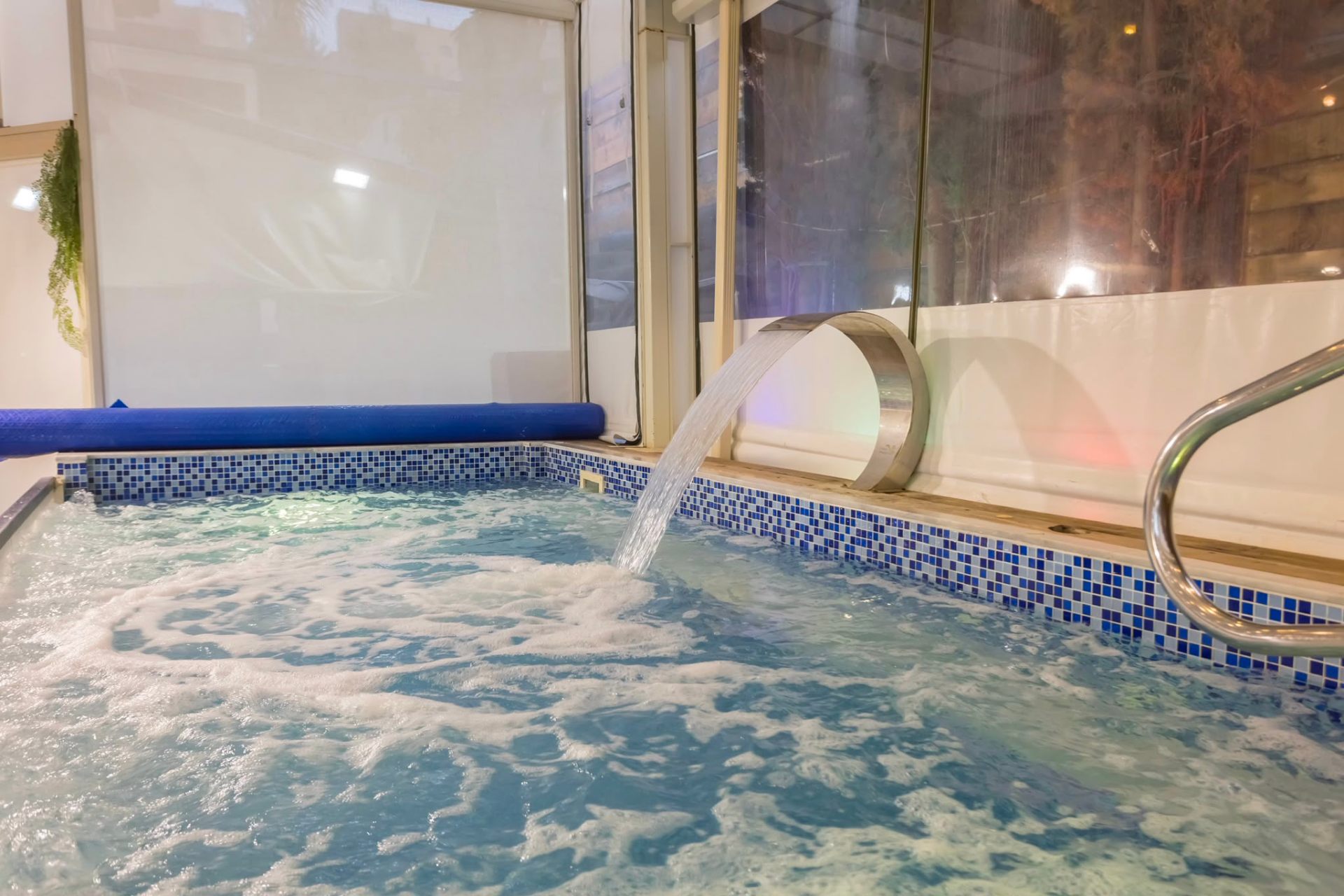Swimming pool with waterfall feature