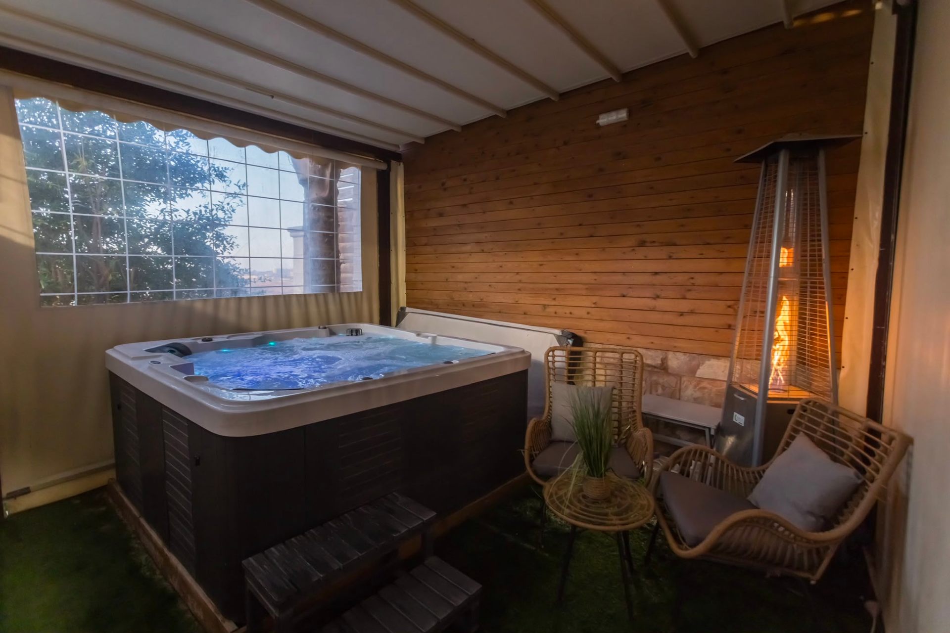 Jacuzzi with seating and warm lighting