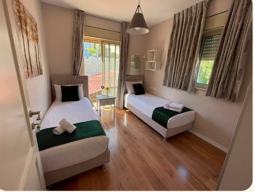 Dormitory room with two beds and large window