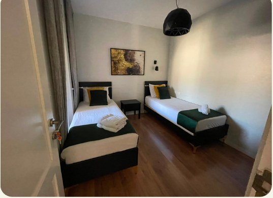 Dormitory room with two beds and warm lighting